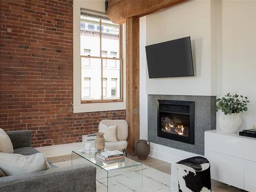 201-610 Johnson St, Victoria, BC - Indoor Photo Showing Living Room With Fireplace