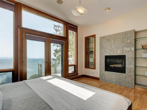 2588 Seaside Dr, Sooke, BC - Indoor Photo Showing Bedroom With Fireplace
