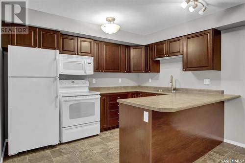 106 215 Smith Street N, Regina, SK - Indoor Photo Showing Kitchen With Double Sink
