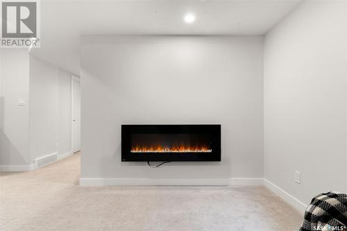 103 3121 Green Bank Road, Regina, SK - Indoor Photo Showing Living Room With Fireplace