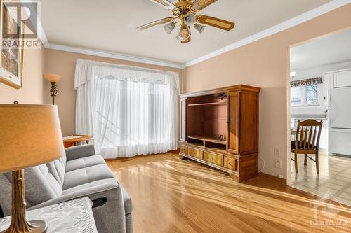 The same room pictured from a different angle. Notice the ceiling fans and the decorative crown molding all around. - 927-931 Laurier Street, Rockland, ON - Indoor