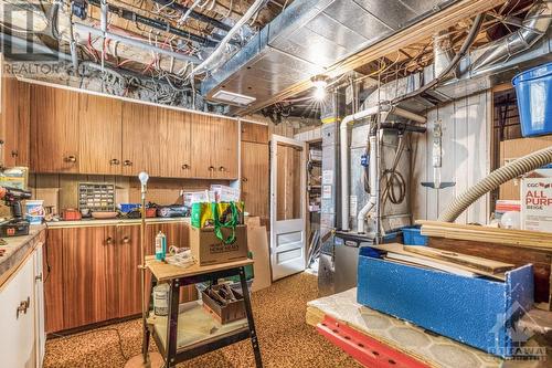 The handyman of the family will love this workshop/utility room offering another long storage room behind the gas forced air furnace with central a/c. - 927-931 Laurier Street, Rockland, ON - Indoor Photo Showing Basement