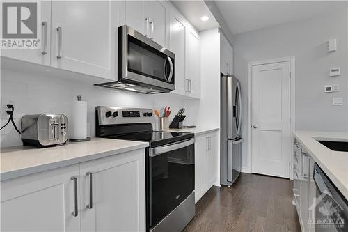 super handy walk in pantry just beyond fridge - 800 Cap Diamant Way, Ottawa, ON - Indoor Photo Showing Kitchen With Stainless Steel Kitchen With Upgraded Kitchen