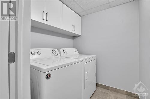 3rd floor laundry with overhead cabinets.  Laundry pair is included. - 800 Cap Diamant Way, Ottawa, ON - Indoor Photo Showing Laundry Room