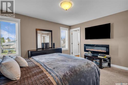 605 Regier Place, Martensville, SK - Indoor Photo Showing Bedroom With Fireplace