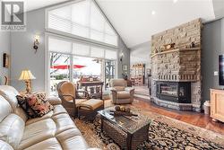 Living Room with Beautiful Stone Wood Fireplace and Vaulted Ceiling - 