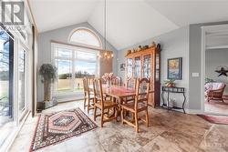 View of Dining area from Kitchen with Vaulted Ceilings and a beautiful view of the Backyard - 