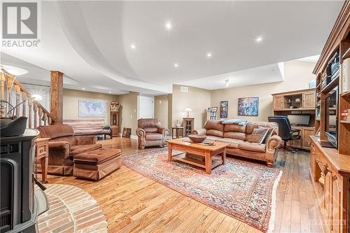 Basement has 9' Ceilings and Hardwood throughout - Large Family Room with Pellet Stove and Skylight Windows for Natural Light - 6980 Mansfield Road, Stittsville, ON - Indoor Photo Showing Living Room