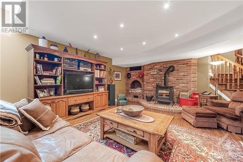 Basement - Large Family Room with Pellet Stove. Supplementary Baseboard heating available, if needed! - 6980 Mansfield Road, Stittsville, ON - Indoor Photo Showing Living Room With Fireplace