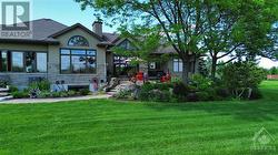 Backyard Photo of House with Beautiful Garden and Greenery - 