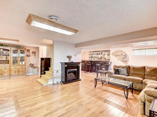 Sous-sol - 1390 Av. Stravinski, Brossard, QC - Indoor Photo Showing Living Room With Fireplace