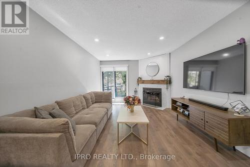 614 - 95 Trailwood Drive, Mississauga, ON - Indoor Photo Showing Living Room With Fireplace