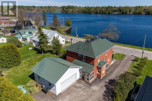 Paved drive. Kitchen jut out is seating area. Back entrance from driveway and garage. - 1094 Madawaska Street, Calabogie, ON - Outdoor With Body Of Water With View