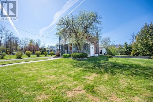 Impressive curb appeal - walkway, flower bed, screened in porch with enclosed balcony. - 1094 Madawaska Street, Calabogie, ON - Outdoor