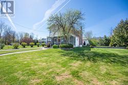 Impressive curb appeal - walkway, flower bed, screened in porch with enclosed balcony. - 