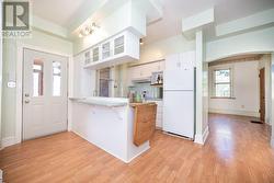 Kitchen entrance from rear porch or garage. Formal dining room, and bathroom door ahead. - 