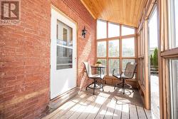 Kitchen entry from rear enclosed porch. - 