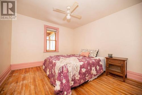 Bedroom 1 of 2 facing the lake. Window into enclosed balcony. - 1094 Madawaska Street, Calabogie, ON - Indoor Photo Showing Bedroom