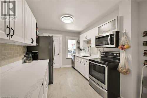 Such a gorgeous kitchen with new appliances and plenty of storage for all your treasures! - 15 Newlands Avenue, Hamilton, ON - Indoor Photo Showing Kitchen