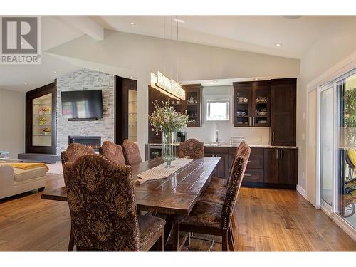 10626 Okanagan Centre Road E, Lake Country, BC - Indoor Photo Showing Dining Room With Fireplace