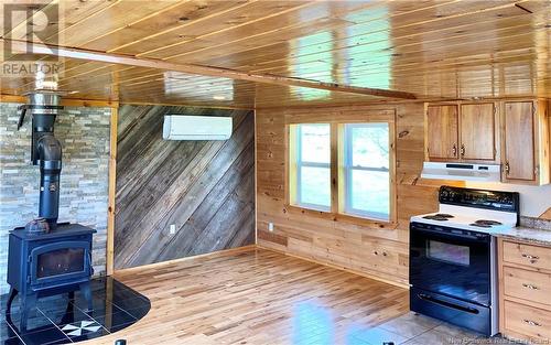 23 Route 610, Upper Hainesville, NB - Indoor Photo Showing Kitchen With Fireplace