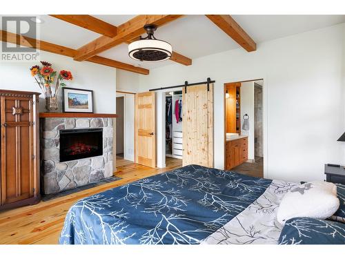 2078 Huckleberry Road, Kelowna, BC - Indoor Photo Showing Bedroom With Fireplace
