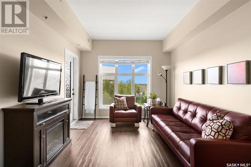 411 1220 Blackfoot Drive, Regina, SK - Indoor Photo Showing Living Room With Fireplace