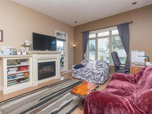 204-623 Treanor Ave, Langford, BC - Indoor Photo Showing Living Room With Fireplace