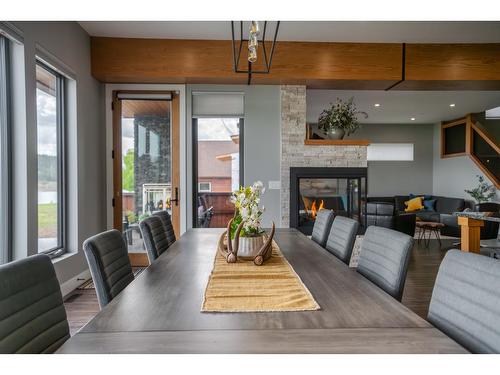 1574 Koocanusa Lake Drive, Lake Koocanusa, BC - Indoor Photo Showing Dining Room With Fireplace