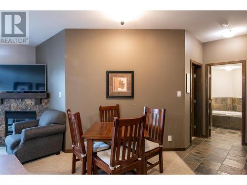 1545 Kicking Horse Trail Unit# 107, Golden, BC - Indoor Photo Showing Dining Room With Fireplace