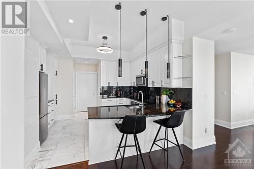 3 capped electrical outlets over the breakfast bar, upgraded kitchen cabinets, 4 pantry roll-out drawers, and 2 sets of pot/pan drawers (2 deep, 1 shallow) - 805 Carling Avenue Unit#4003, Ottawa, ON - Indoor Photo Showing Kitchen With Upgraded Kitchen