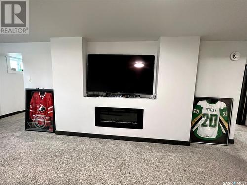 395 4Th Avenue Nw, Swift Current, SK - Indoor Photo Showing Other Room With Fireplace