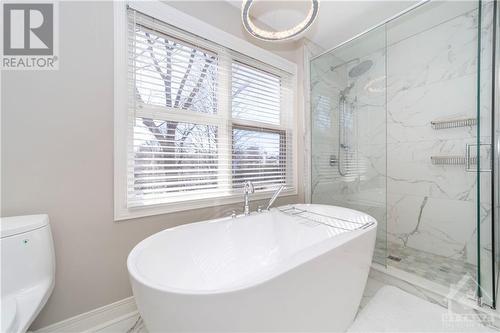 Renovated Primary En-Suite with Quartz Counters, Soaker Tub and Glass Shower - 48 Marble Arch Crescent, Ottawa, ON - Indoor Photo Showing Bathroom