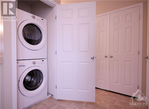 Stackable washer/dryer - 3415 Cambrian Road, Ottawa, ON - Indoor Photo Showing Laundry Room