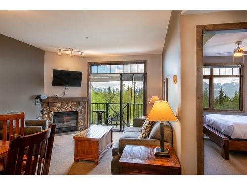 303 - 1549 Kicking Horse Trail, Golden, BC - Indoor Photo Showing Living Room With Fireplace