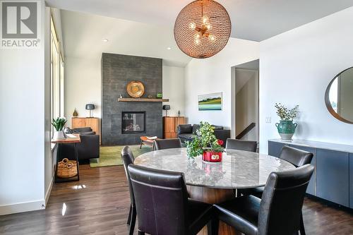 1459 Rocky Point Drive, Kelowna, BC - Indoor Photo Showing Dining Room With Fireplace