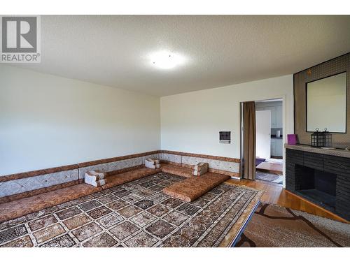 360 Hardie Road, Kelowna, BC - Indoor Photo Showing Bedroom With Fireplace