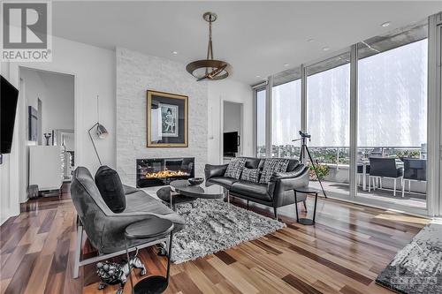 Living room is grandiose, centered around a tiled fireplace and surrounded by floor-to-ceiling wall-to-wall windows. - 111 Champagne Avenue S Unit#2004, Ottawa, ON - Indoor Photo Showing Living Room With Fireplace