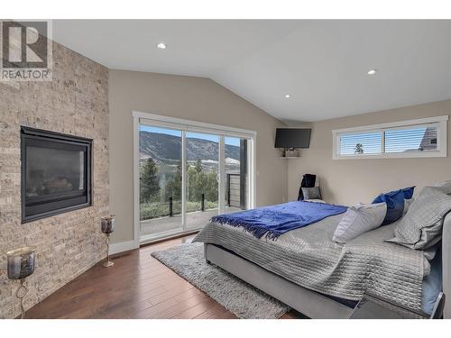 4511 Crawford Road, Lake Country, BC - Indoor Photo Showing Bedroom With Fireplace