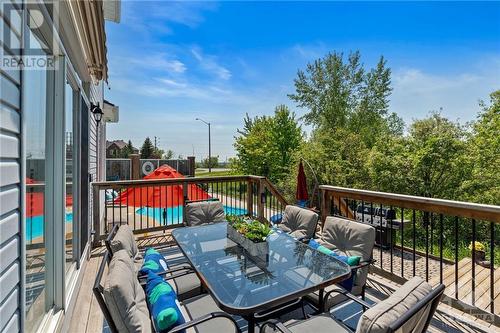 Upper deck off the kitchen offers a view of the pool & gazebo, making it a convenient spot for entertaining & family dinners. Perfect for working from home while enjoying the outdoors. - 2181 Des Grands Champs Way, Ottawa, ON - Outdoor With Deck Patio Veranda With Exterior