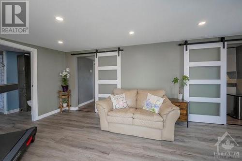 Family room off side entrance with lovely sliding doors. These owners definitely had a vision for making this home welcoming. - 171 Gardiner Shore Road, Carleton Place, ON - Indoor Photo Showing Living Room