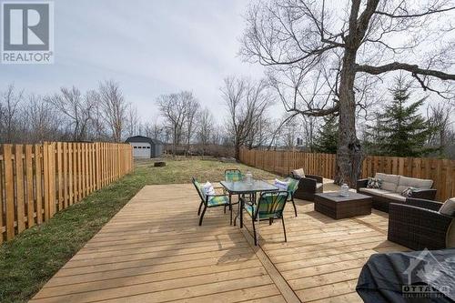 lovely deep lot showing the large back deck and a glimpse of the large shed/portable garage tucked in the back - 171 Gardiner Shore Road, Carleton Place, ON - Outdoor With Deck Patio Veranda