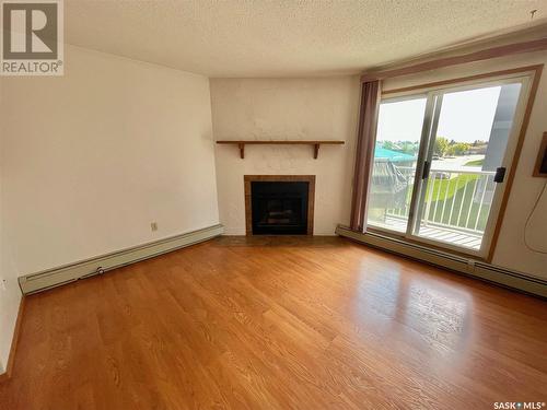 414 2410 Heseltine Road, Regina, SK - Indoor Photo Showing Living Room With Fireplace
