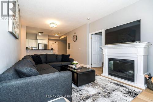 718 - 16 Dallimore Circle, Toronto, ON - Indoor Photo Showing Living Room With Fireplace