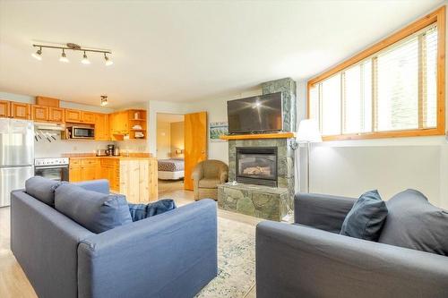 300 - 4559 Timberline Crescent, Fernie, BC - Indoor Photo Showing Living Room With Fireplace