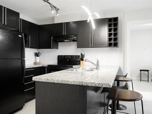 209-1093 Sunset Drive, Kelowna, BC - Indoor Photo Showing Kitchen With Double Sink With Upgraded Kitchen