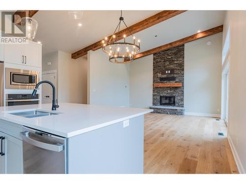 695 Killough  Road, Castlegar, BC - Indoor Photo Showing Kitchen With Fireplace With Double Sink