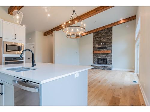 695 Killough Road, Castlegar, BC - Indoor Photo Showing Kitchen With Fireplace With Double Sink