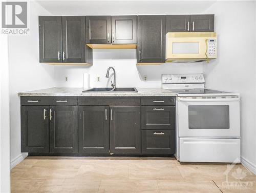 Virtually staged - 43 Government Road E, Kirkland Lake, ON - Indoor Photo Showing Kitchen With Double Sink