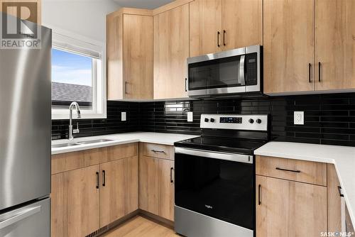 7664 Mapleford Boulevard, Regina, SK - Indoor Photo Showing Kitchen With Stainless Steel Kitchen With Double Sink